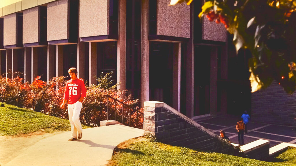 A student strolls by Noyes Community Center on West Campus, 1973